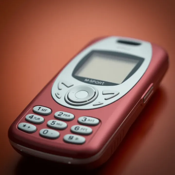 Detailed View of the 2013 M-Sport Mobile Design Close-up view of a vintage M-Sport mobile showcasing its compact design and physical keypad